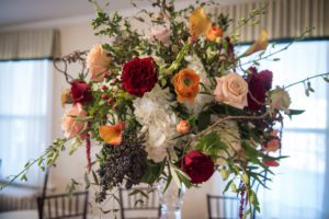 Weddings at Tarrywile Beautiful Centerpiece red peach orange flowers