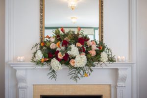 Weddings at Tarrywile large floral arrangement on the fireplace mantle