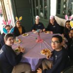 Egg Hunt Volunteers fundraising-volunteers-sitting-around-table-eating-with-bunny-ears-on