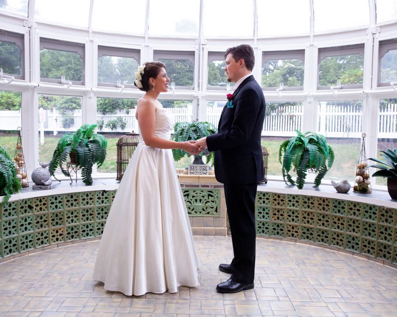 Wedding Photo's cuban-flair-wedding-rachel-robert-holdiing-hands-in-glass-conservatory
