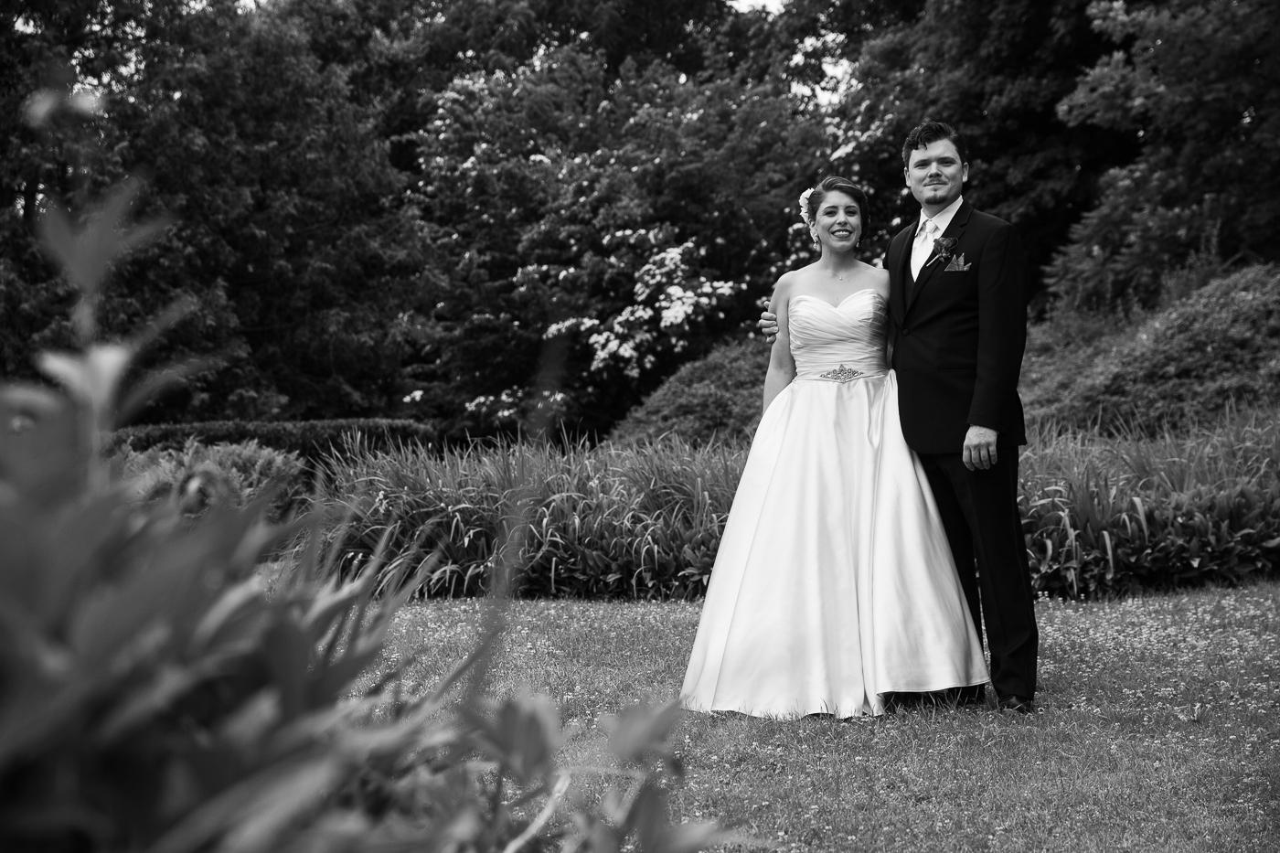 Weddings at Tarrywile bride and groom posing in flower garden