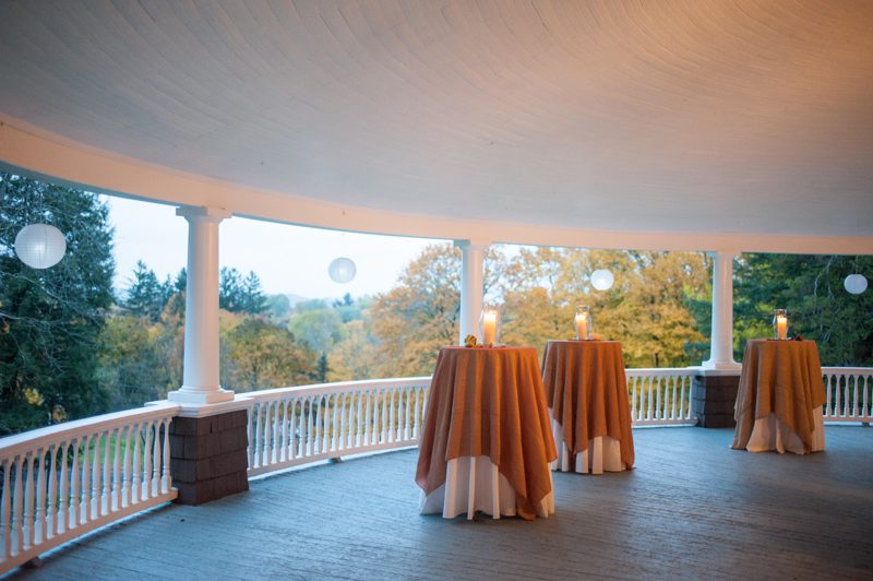 veranda set up with hi cocktail tables overlooking the fall vista